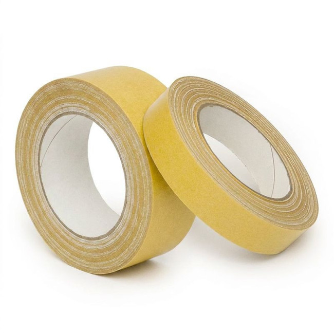 CINTA ADHESIVA DOBLE CARA. TEJIDO DE ALGODÓN. PAPEL BISILICONADO. PARA MOQUETAS. APLICACIONES DE MONTAJE. ANCHO 25MM - A